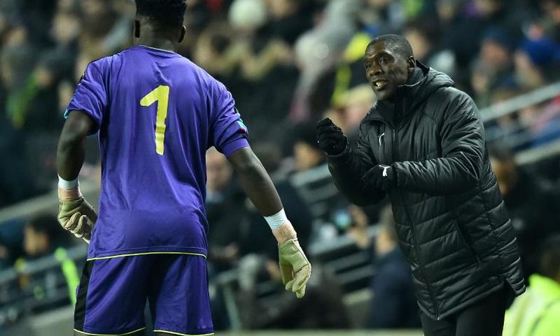 Cameroon coach Clarence Seedorf instructs goalkeeper Andre Onana during a 1-0 friendly loss to Brazil in England last November
