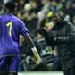 Cameroon coach Clarence Seedorf instructs goalkeeper Andre Onana during a 1-0 friendly loss to Brazil in England last November