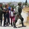 Mexican National Guard soldiers detain Central American migrants trying to cross the Rio Bravo - also known as the Rio Grande - into the United States at Ciudad Juarez