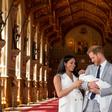 Britain's Prince Harry, Duke of Sussex (R), and his wife Meghan, Duchess of Sussex, pose with their newborn baby son, Archie Harrison Mountbatten-Windsor, in St George's Hall at Windsor Castle