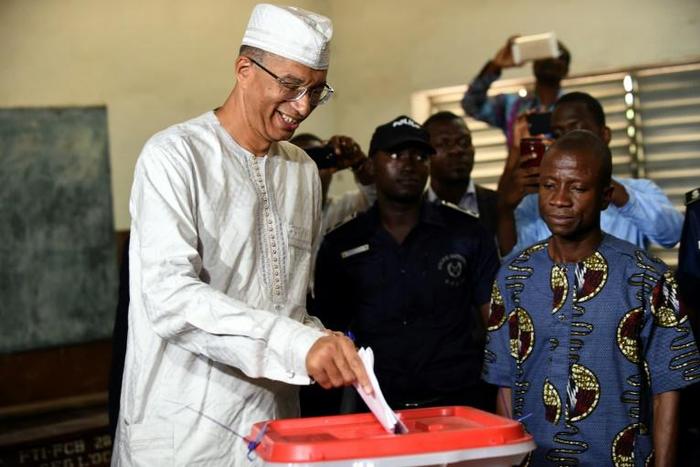Former prime minister Lionel Zinsou (L), who lives in France, was found guilty of using false documents and "exceeding" spending limits in his 2016 presidential bid