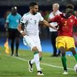 Algerian star Riyad Mahrez (L) tries to prevent Guinean Issiaga Sylla crossing during an Africa Cup of Nations last-16 match in Cairo