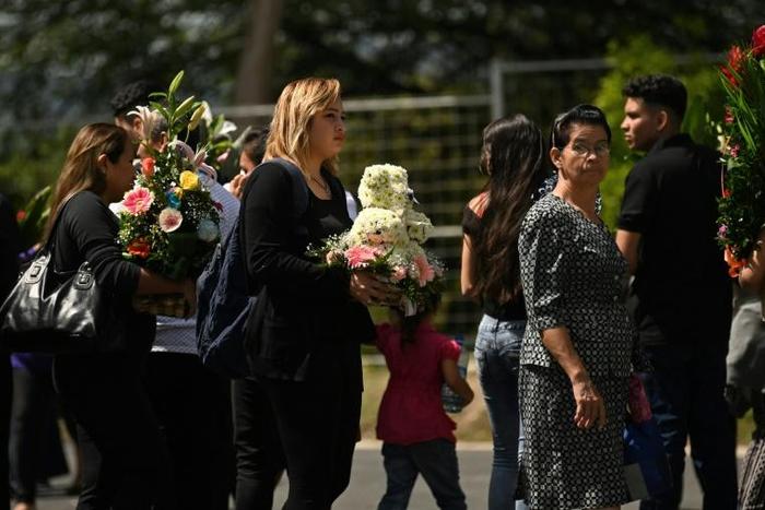 People attending the funeral in San Salvador of Oscar Martinez and his 23-month-old daughter Valeria, who both drowned while trying to cross the Rio Grande from Mexico to the United States