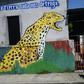 A woman walks by a mural in Ciudad Hidalgo, Chiapas State, Mexico, on June 6, 2019