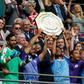Manchester City's Argentinian striker Sergio Aguero (CL) and Manchester City's Spanish midfielder David Silva (CR) raise the trophy after winning the English FA Community Shield football match between Manchester City and Liverpool