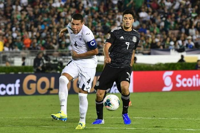 Cuba's Yasmani Lopez (L) vies for the ball with Mexico's forward Raul Jimenez (R) during their Concacaf Gold Cup match in California -- after which Lopez defected