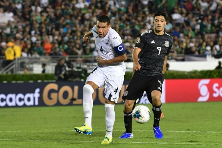 Cuba's Yasmani Lopez (L) vies for the ball with Mexico's forward Raul Jimenez (R) during their Concacaf Gold Cup match in California -- after which Lopez defected