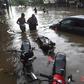 Lahore residents wade through a flooded street after heavy monsoon rains in the Pakistan city