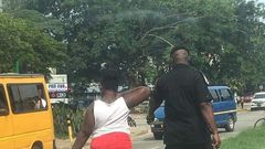 Woman made to pick litter after caught throwing sachet water bag on the street