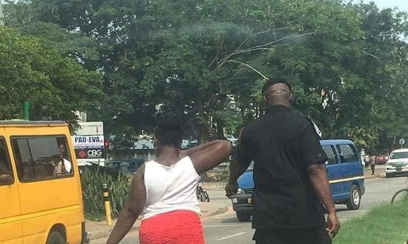 Woman made to pick litter after caught throwing sachet water bag on the street