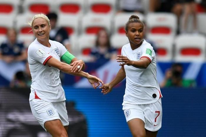 Nikita Parris (R) celebrates with skipper Steph Houghton after putting England in front against Scotland from the penalty spot