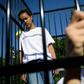 Three teens wearing t-shirts with "#ClassroomsNotCages" scrawled across the front stood inside a small cage erected outside the gates of the United Nations's European headquarters
