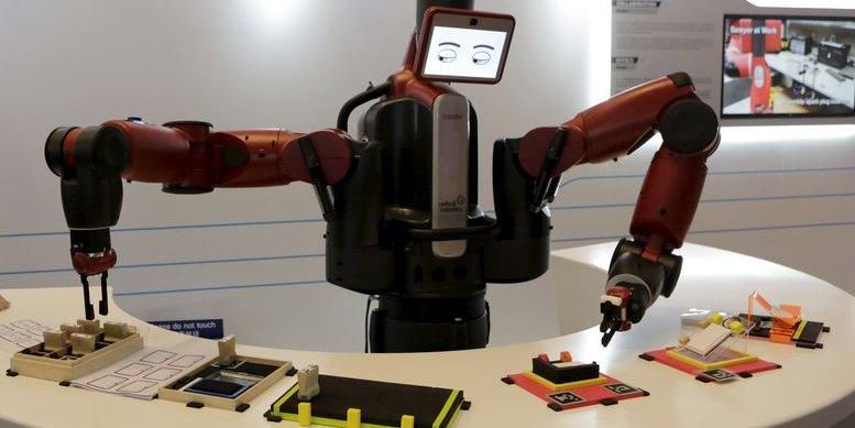 A Baxter robot of Rethink Robotics picks up a business card as it performs during a display at the World Economic Forum (WEF), in China's port city Dalian, Liaoning province, China, September 9, 2015. REUTERS/Jason Lee
