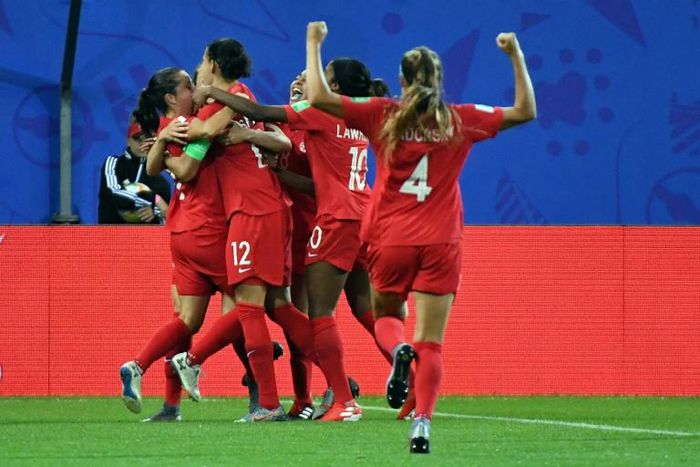 Canadian players submerged Jessie Fleming after she scored the opening goal against New Zealand
