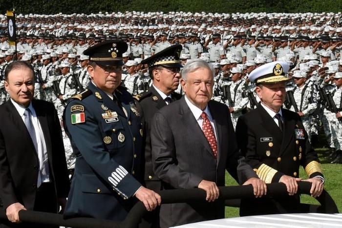 President Andres Manuel Lopez Obrador (C) and his top military brass review members of Mexico's new security force, the National Guard
