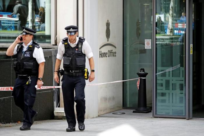 After the stabbing security cordon tape was put up around the entrance of the inteiror ministry while guards and police officers were stood outside
