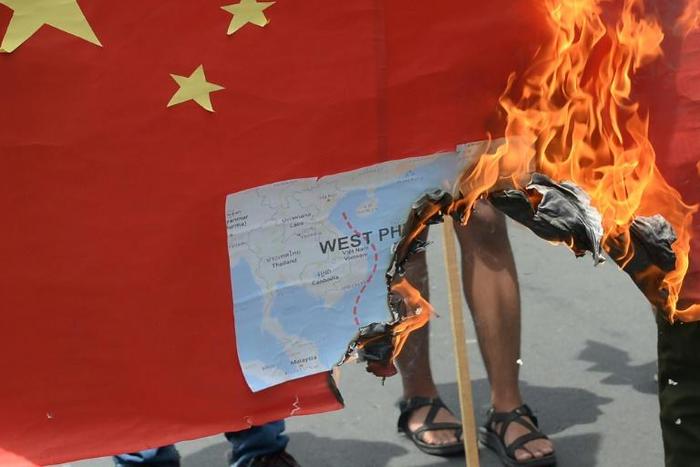 Activists burned a mock Chinese flag with a map of the South China Sea during a protest in front of the Chinese consulate in Manila on June 12, 2019