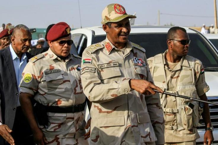 Mohamed Hamdan Dagalo (C), deputy head of Sudan's ruling Transitional Military Council (TMC) and commander of the Rapid Support Forces (RSF) paramilitaries, is escorted through the village of Qarri, north of Khartoum, on June 15, 2019