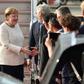Germany's Chancellor Angela Merkel (L) is greeted by well-wishers upon her arrival in Japan for the G20 summit as officials sought to play down fears over her health