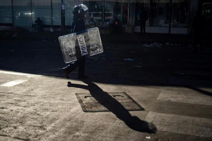 Police officers looks on as he patrols near Tredgold Magistrates courts on August 19, 2019, in Bulawayo, Zimbabwe