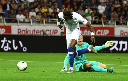Chelsea forward Tammy Abraham (L) scores a goal past Barcelona goalkeeper Marc-Andre ter Stegen during their friendly in Saitama, Japan