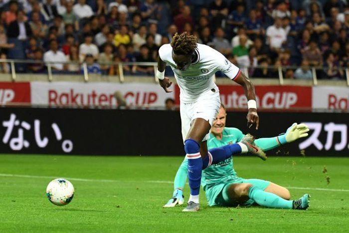 Chelsea forward Tammy Abraham (L) scores a goal past Barcelona goalkeeper Marc-Andre ter Stegen during their friendly in Saitama, Japan