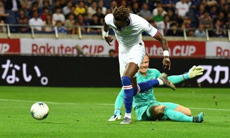 Chelsea forward Tammy Abraham (L) scores a goal past Barcelona goalkeeper Marc-Andre ter Stegen during their friendly in Saitama, Japan