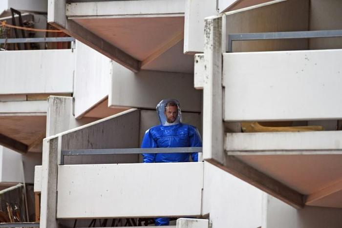 A forensic expert on a balcony at the apartment building in Cologne where a Tunisian-German couple are suspected of producing the deadly poison ricin
