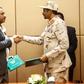 General Mohamed Hamdan Daglo (R), deputy head of Sudan's ruling military council, and protest movement leader Ahmed Rabie shake hands after signing the constitutional declaration at a ceremony in Khartoum