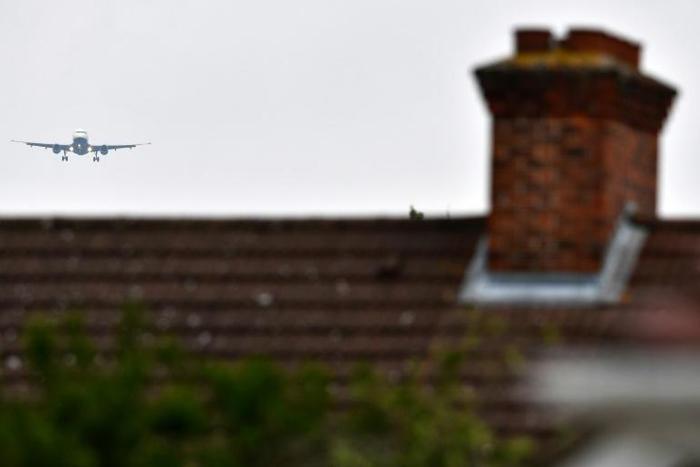 File picture shows a plane flying over residential houses as it prepares to land at London Heathrow Airport