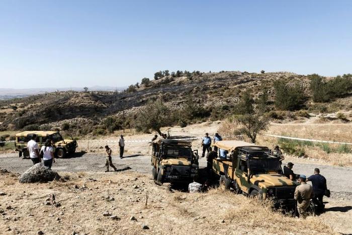 Security forces in northern Cyprus inspect the site where a suspected Russian missile exploded