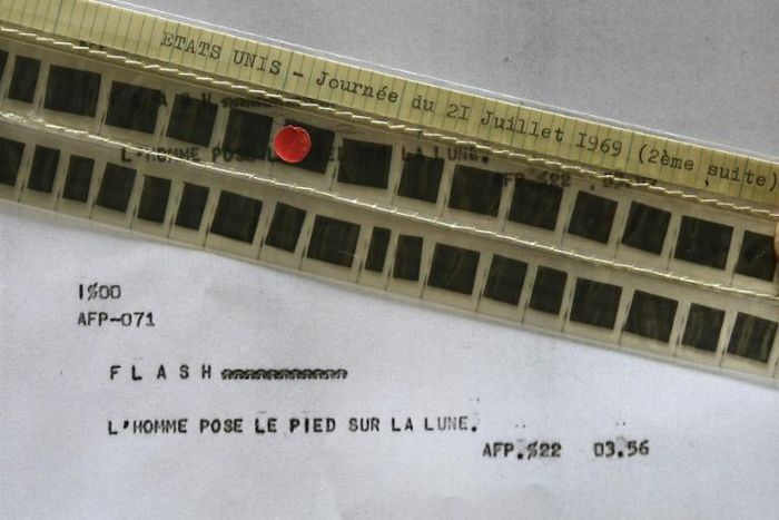 This 2019 photograph shows the AFP flash, stored in the agency's microfilmed archives, that announced that man had stepped on the Moon for the first time in July 1969