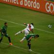 Peru's Jefferson Farfan (center) jumps over Bolivia's Marvin Bejarano to head home the decisive goal at the Copa America