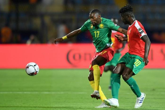 Cameroon forward Karl Toko Ekambi (L) attacks against Guinea-Bissau at the Africa Cup of Nations in Egypt