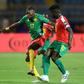 Cameroon forward Karl Toko Ekambi (L) attacks against Guinea-Bissau at the Africa Cup of Nations in Egypt