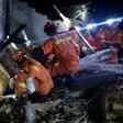 Rescuers search for earthquake survivors in the rubble of a building in Yibin, in China's Sichuan province