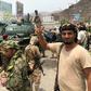 Yemeni supporters of the southern separatist movement pose for a picture with a tank they confiscated from a military barracks in Aden where they have been fighting other forces loyal to the internationally recognised government