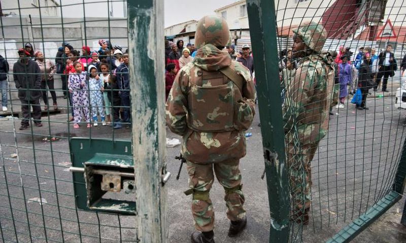 South African National Defense Force troops patrol a Cape Town street in one of the areas ravaged by gang violence