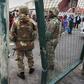 South African National Defense Force troops patrol a Cape Town street in one of the areas ravaged by gang violence