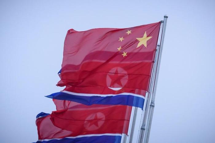 North Korean and Chinese flags fly on Kim Il Sung square in Pyongyang