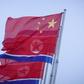 North Korean and Chinese flags fly on Kim Il Sung square in Pyongyang