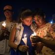 People hold candles as they pray during a candlelight vigil at the Immanuel Church for victims of a shooting that left a total of 22 people dead at the Cielo Vista Mall WalMart in El Paso, Texas, on August 5, 2019