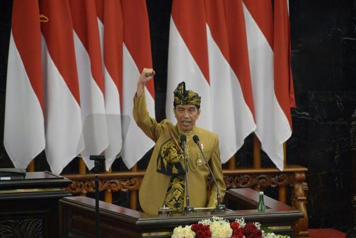 President Joko Widodo, wearing a traditional outfit for his address, wants to relocate the Indonesian capital to the island of Borneo but did not give a timetable for the move