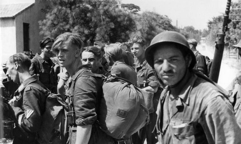 Algerian riflemen guarding German prisoners in Marseille, southern France, in August 1944