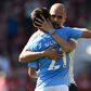 Manchester City manager Pep Guardiola embraces Spanish midfielder David Silva