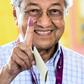 Mahathir Mohamad shows his inked finger after casting his vote in the 2018 election that saw him returned to power