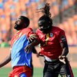 DR Congo's forward Cedric Bakambu (L) fights for the ball with Uganda's defender Hassan Wasswa during the 2019 Africa Cup of Nations (CAN) football match between DR Congo and Uganda at Cairo International Stadium on June 22, 2019.