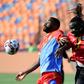 DR Congo's forward Cedric Bakambu (L) fights for the ball with Uganda's defender Hassan Wasswa during the 2019 Africa Cup of Nations (CAN) football match between DR Congo and Uganda at Cairo International Stadium on June 22, 2019.