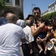 People at the scene of a blast that targeted police on the Tunisian capital's main avenue on Thursday