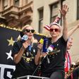 World Cup star Megan Rapinoe waves a US flag as the US women's World Cup-winning soccer team is feted with a ticker tape parade in New York